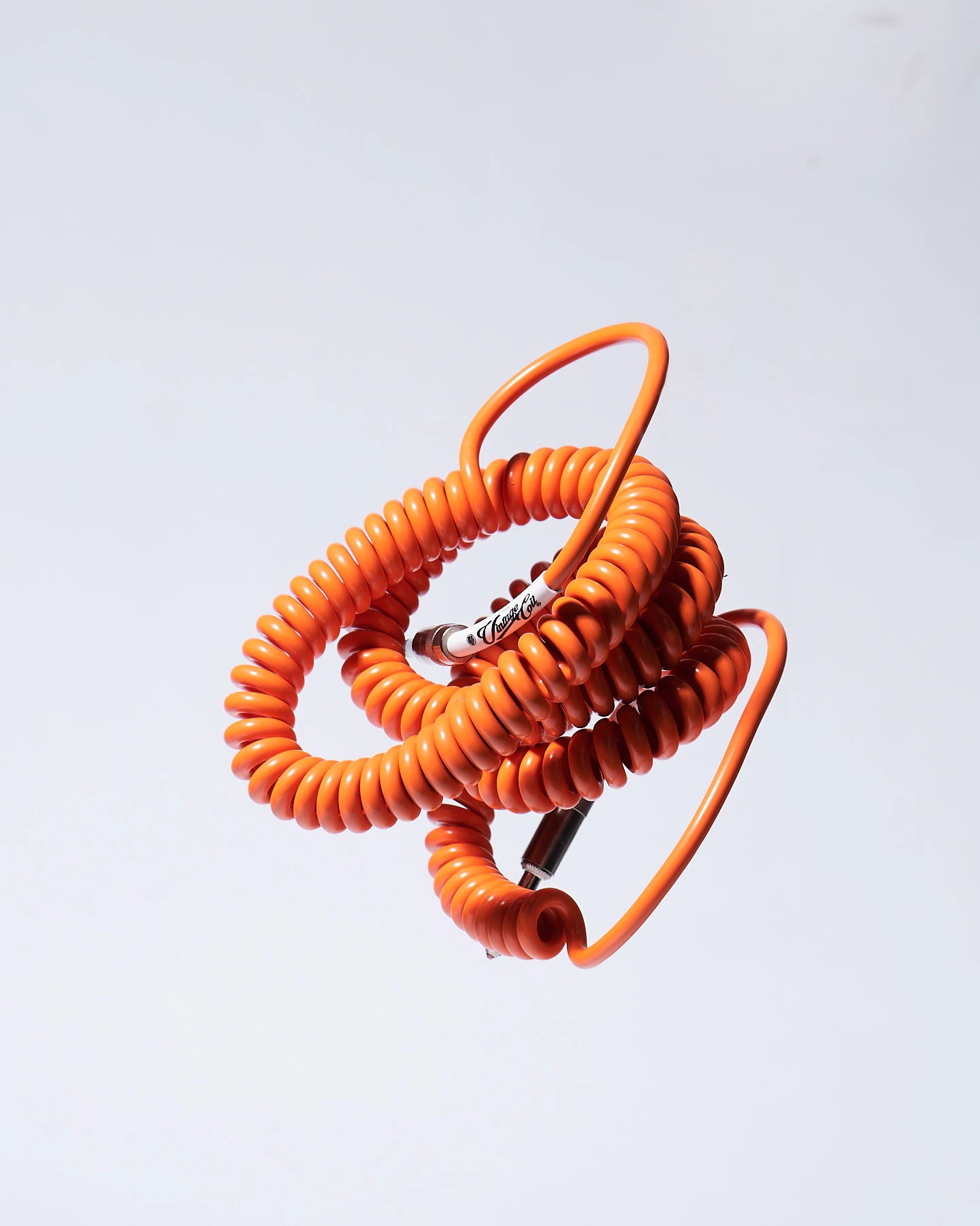 Orange coiled guitar cable product photo Voltage Vintage Coil®