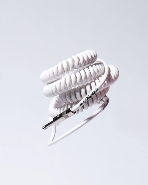 White coiled guitar cable flying product photo Voltage Vintage Coil®