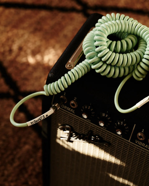 Surf green curly guitar cable on vintage amp
